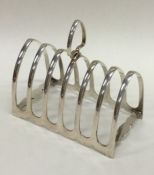 A large heavy silver seven bar toast rack on brack