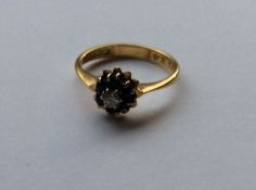 An 18 carat sapphire and diamond circular cluster