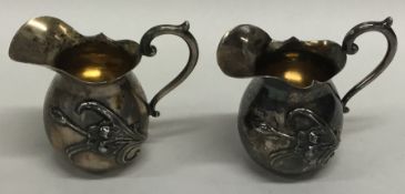 A pair of Continental miniature silver ewers with