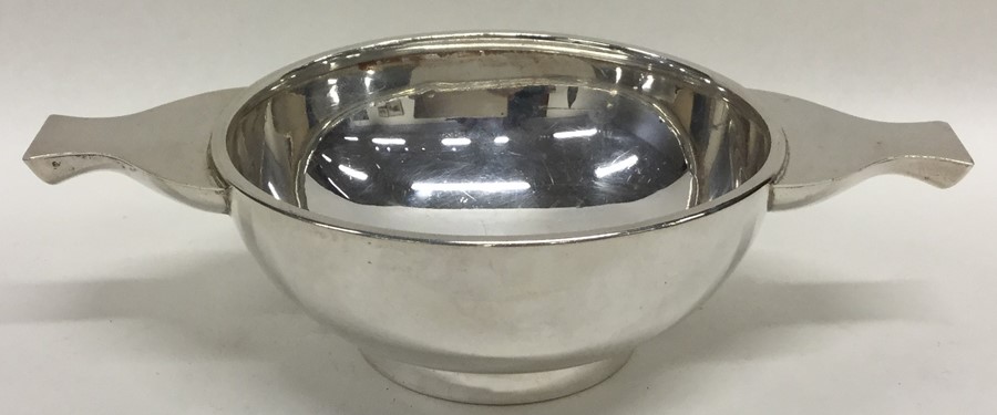 A silver two handled quaich on pedestal base. Lond