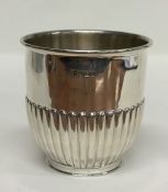 A heavy silver half fluted beaker with gilt interi