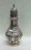 A good cast silver sugar shaker with floral decora