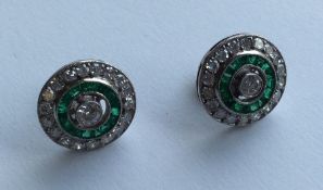A pair of large circular emerald and diamond ear p