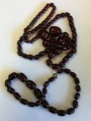 A graduated string of amber type beads together wi