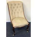 A mahogany button back nursing chair with scroll f
