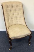 A mahogany button back nursing chair with scroll f