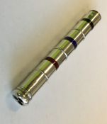 An unusual silver three colour pencil with enamel