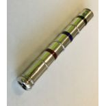 An unusual silver three colour pencil with enamel