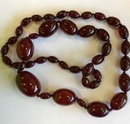 A massive graduated string of red amber beads. App