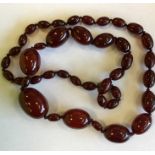 A massive graduated string of red amber beads. App