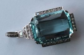A massive aquamarine step cut pendant with diamond