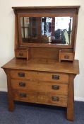 An oak dressing chest of tapering form with shell