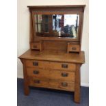 An oak dressing chest of tapering form with shell