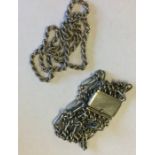 A heavy silver mesh bracelet together with a neckl