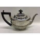 A small half fluted Adams' style silver teapot on