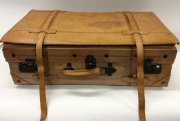 A leather suitcase with hinged decoration. Est. £3