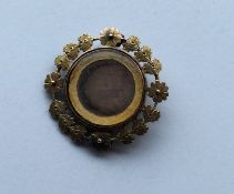 A Georgian gold circular brooch with central dague