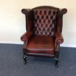 A leather button back smoker's chair on cabriole l