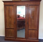 A good mahogany triple door wardrobe decorated wit