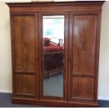 A good mahogany triple door wardrobe decorated wit