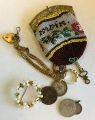 An old needlework purse together with a gate brace