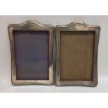 A pair of silver arched top picture frames. Cheste