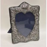 A modern silver heart shaped picture frame decorat