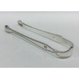 A pair of Georgian silver bright cut sugar tongs.