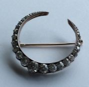 A good Victorian diamond crescent brooch with carv