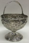 A Continental silver embossed basket decorated wit