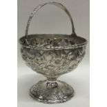 A Continental silver embossed basket decorated wit