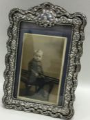 A good silver embossed picture frame with floral d