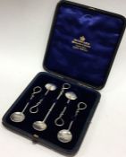 A boxed set of silver cruet spoons with wriggle wo