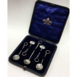 A boxed set of silver cruet spoons with wriggle wo