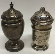 Two Edwardian silver pepperettes on spreading supp