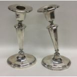 A pair of heavy silver tapering candlesticks with
