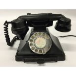 An old bakelite telephone. Est. £20 - £30.