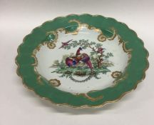 An early Worcester dessert plate decorated with pe