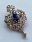 A large sapphire and diamond brooch attractively d