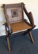 An oak carved hall chair on turned support. Est. £