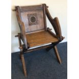 An oak carved hall chair on turned support. Est. £