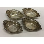 A set of four silver embossed sweet dishes decorat
