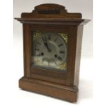 A small mahogany cased mantle clock with silvered