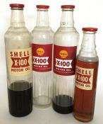 Four various sized "Shell X-100 Motor Oil" glass b