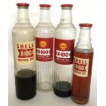 Four various sized "Shell X-100 Motor Oil" glass b