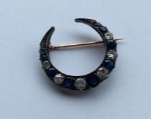 A large sapphire and diamond brooch in the form of