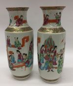 A pair of tall Canton vases decorated with figures