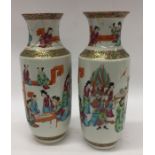 A pair of tall Canton vases decorated with figures