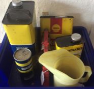 A box containing various oil cans, a plastic Duckh