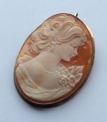 An oval cameo of a lady's head in gold frame. Appr